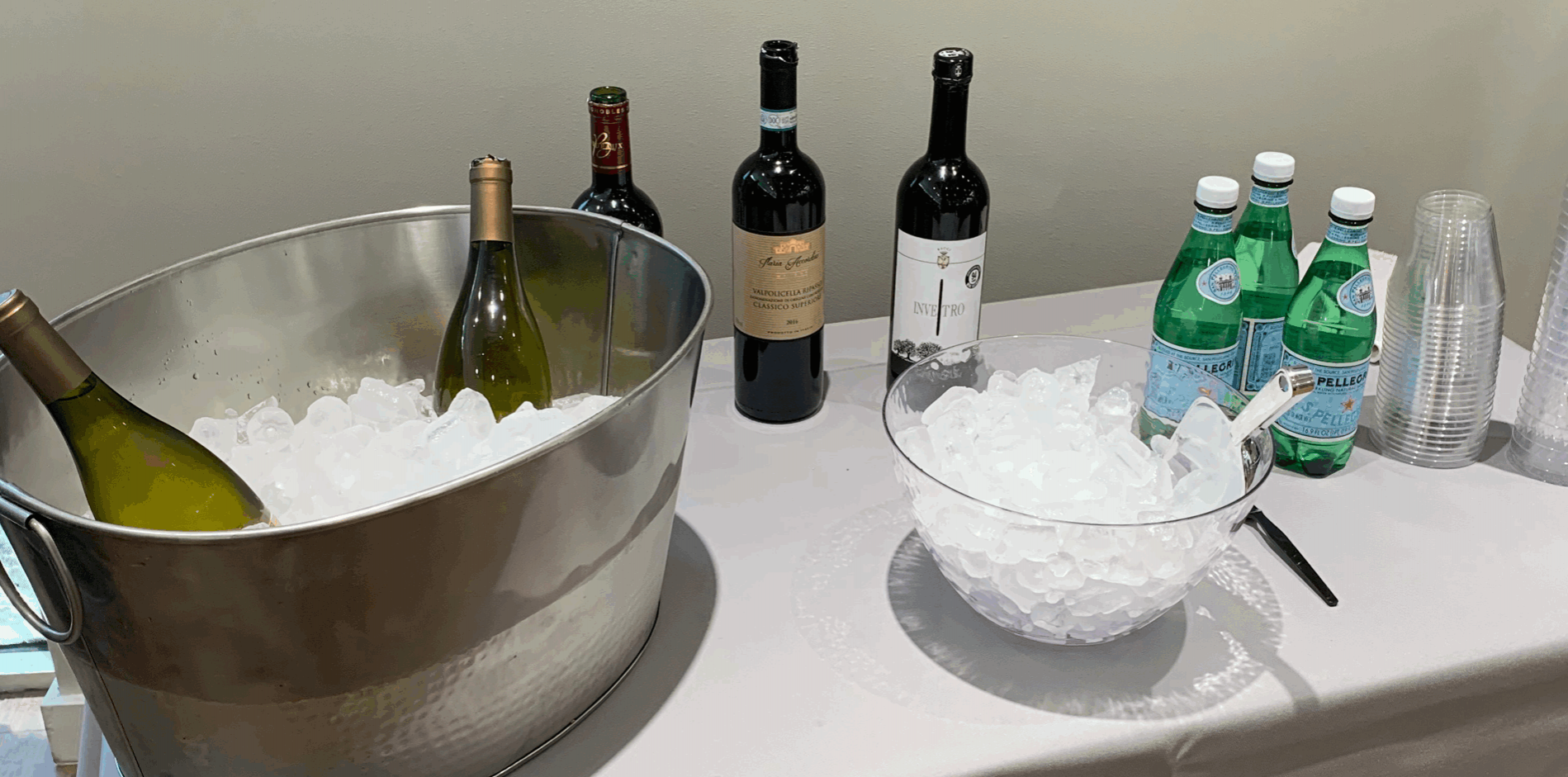 IMG-0972 Web Op NCS Party Planning Top 10 Tips Venice Florida cropped 1900×1460 Drinks and an ice bucket on a white clothed table provided by Nancy's Concierge Services Party Planning